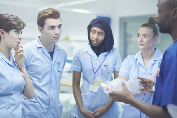 A diverse group of nurses standing together talking