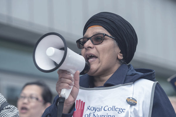 An RCN member on strike with a megaphone