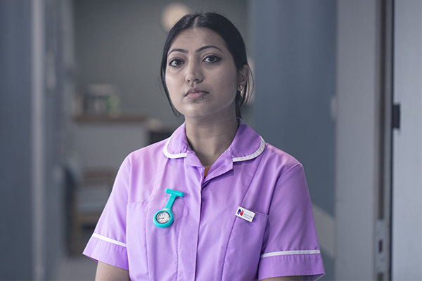 A nurse looking at the camera