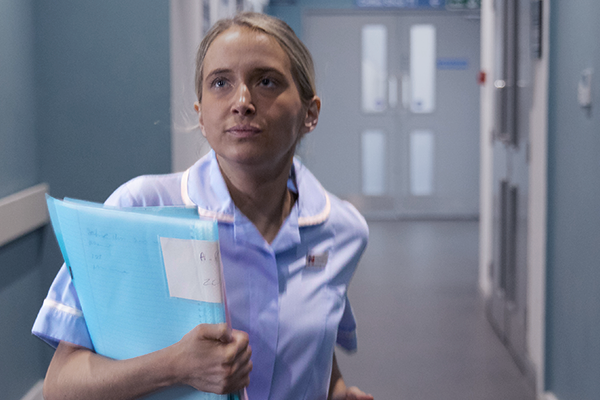 A nurse running down the hallway