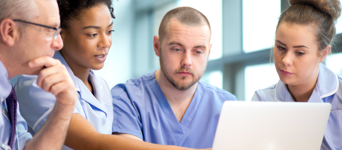 Nurses looking at a laptop