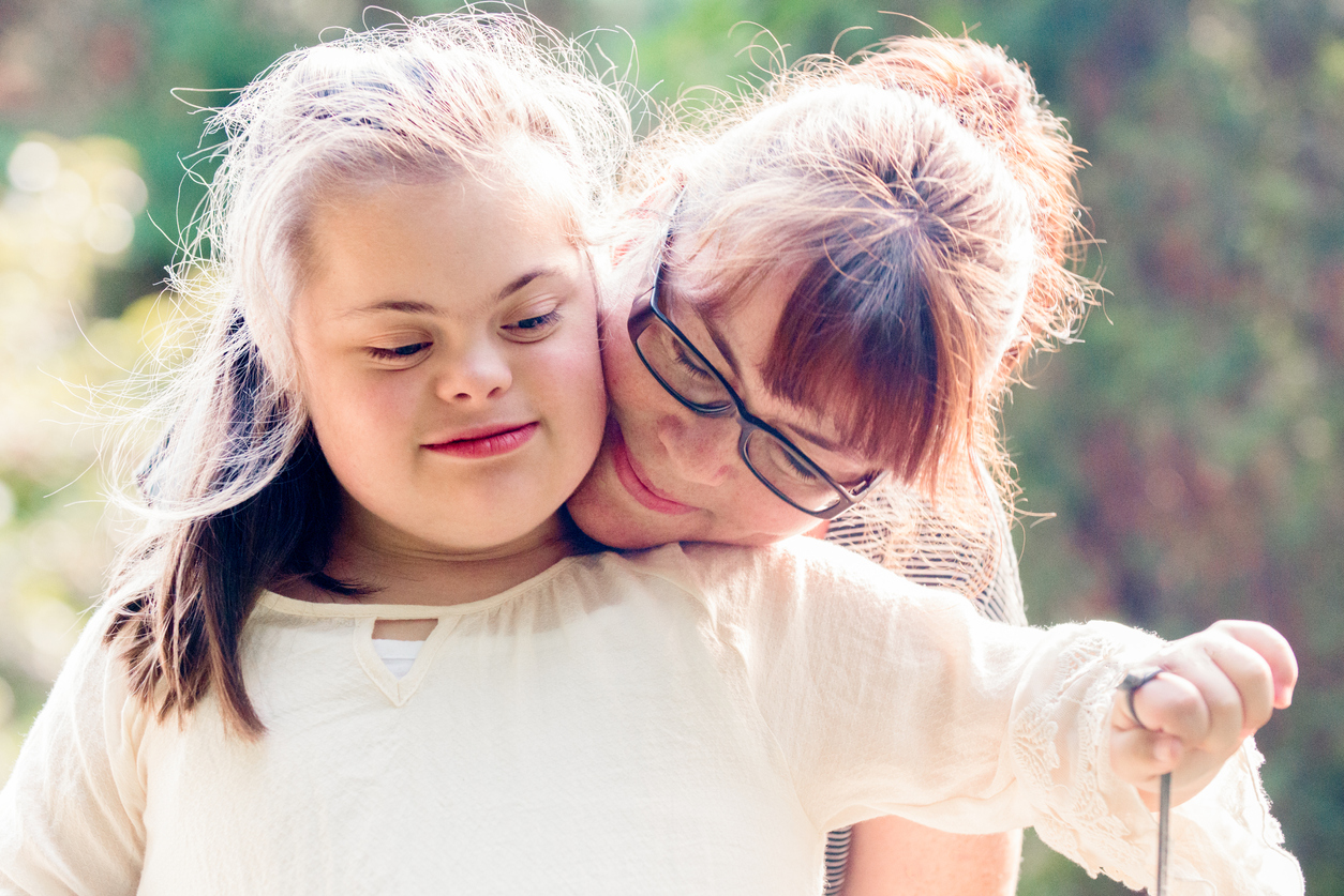 girl with down syndrome with mom