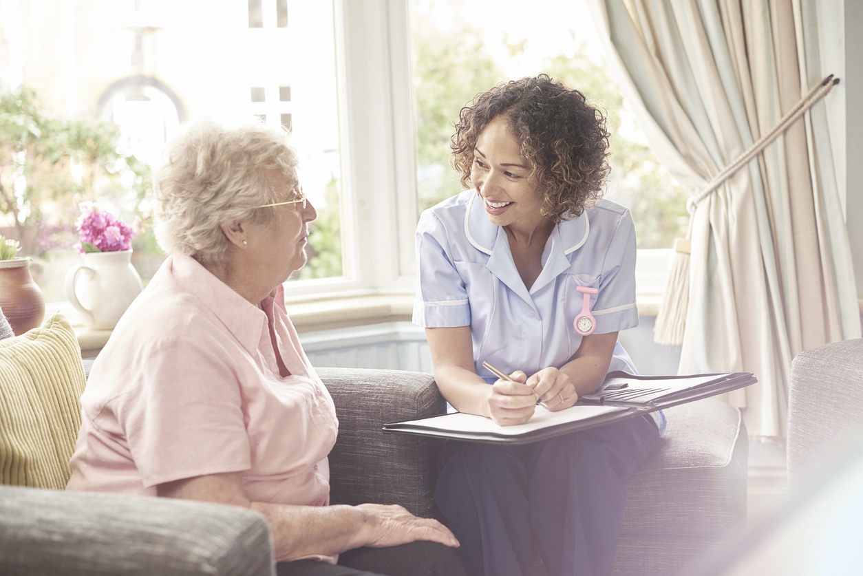 nurse talking to elderly woman