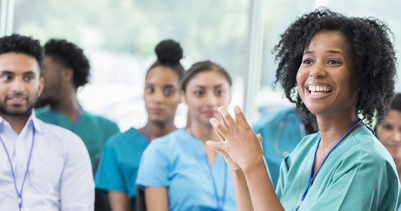 A group of nursing staff sitting in a room