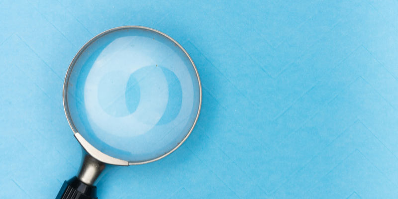 Magnifying glass on blue background