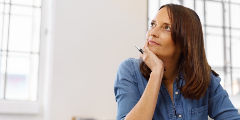 Person sitting and looking thoughtful