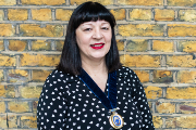 Tracey Budding in front of a brick wall