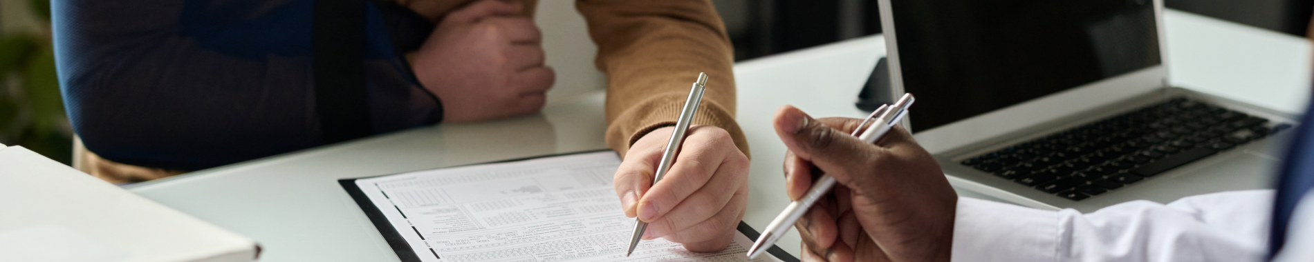 Man filling out a travel insurance form