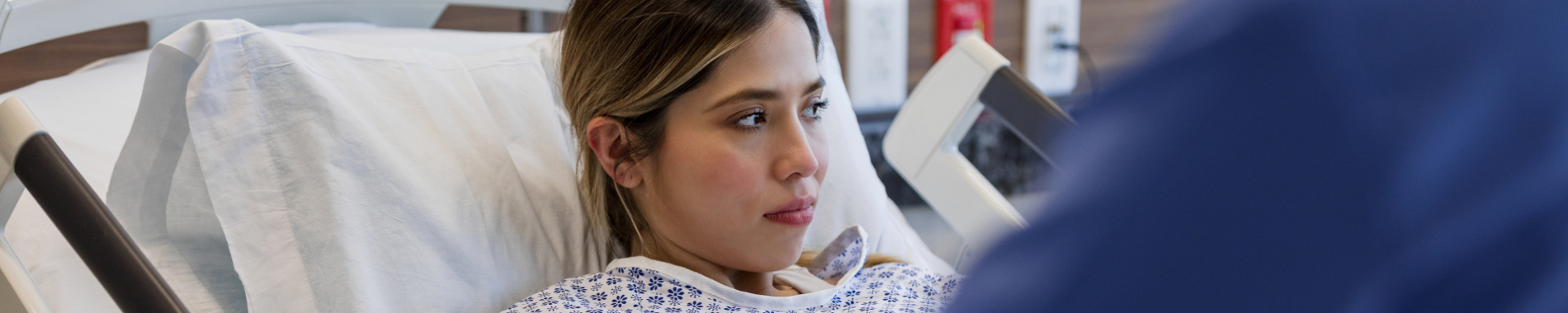 Lady sitting up in a hospital bed