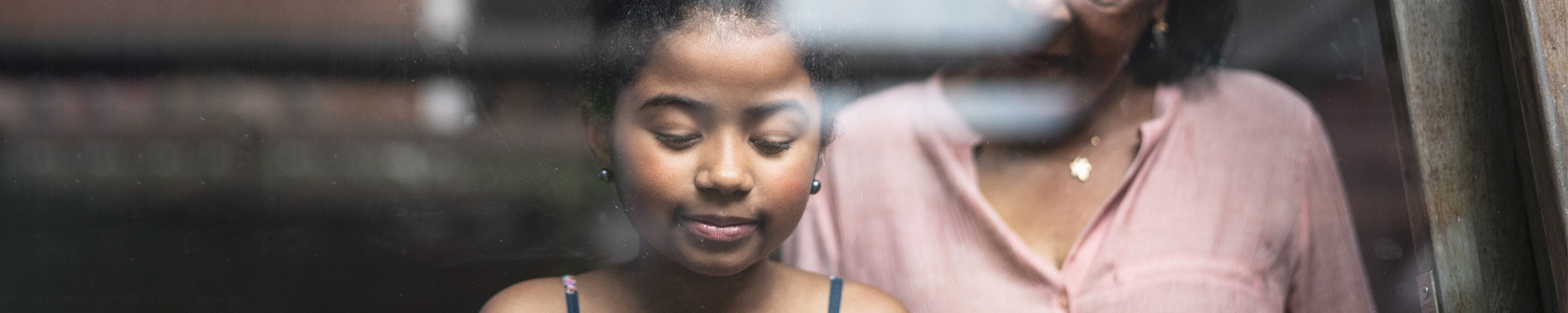 woman looking down at young girl