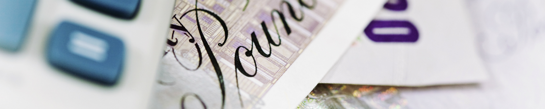 close-up of calculator and banknotes