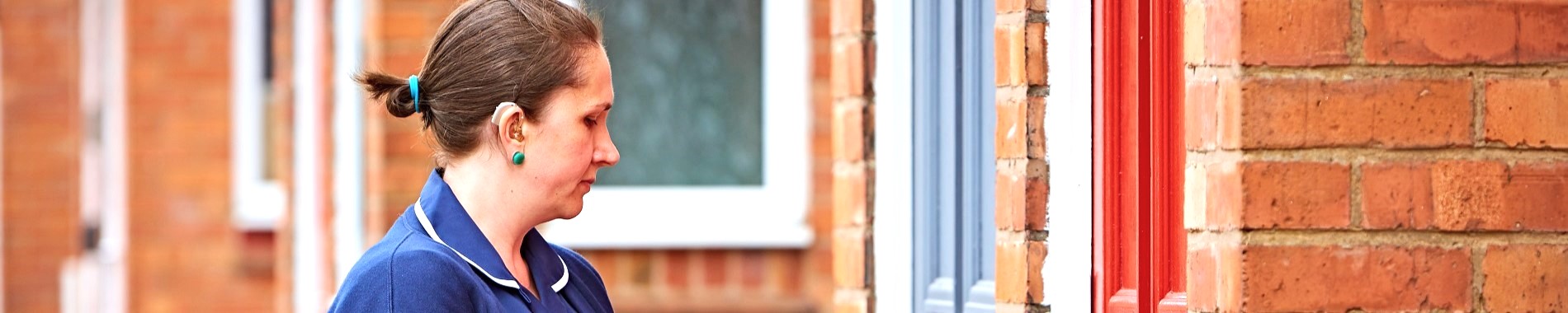 Nurse waiting at a front door