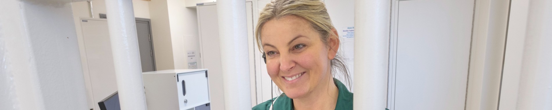 Healthcare support worker dispensing medication in prison