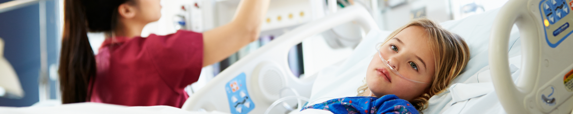 A young girl in a hospital bed in an acute care unit