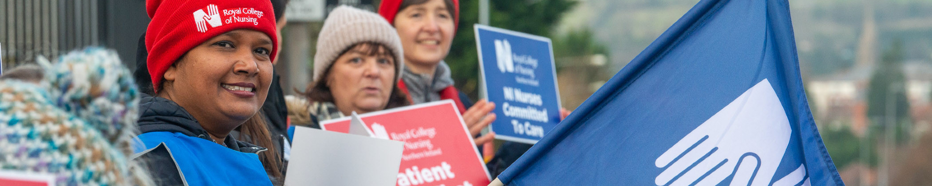 Three nurses striking on a picket line