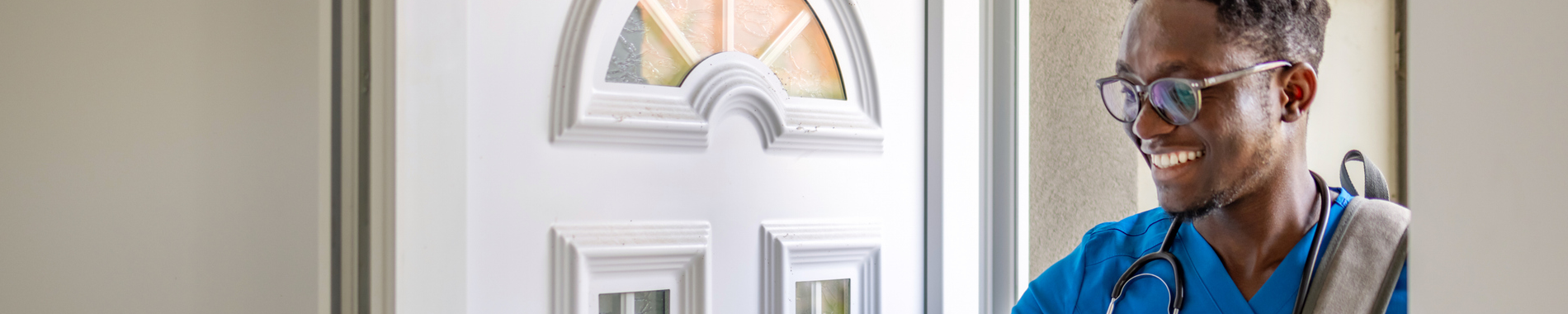 Young male nurse opening his front door