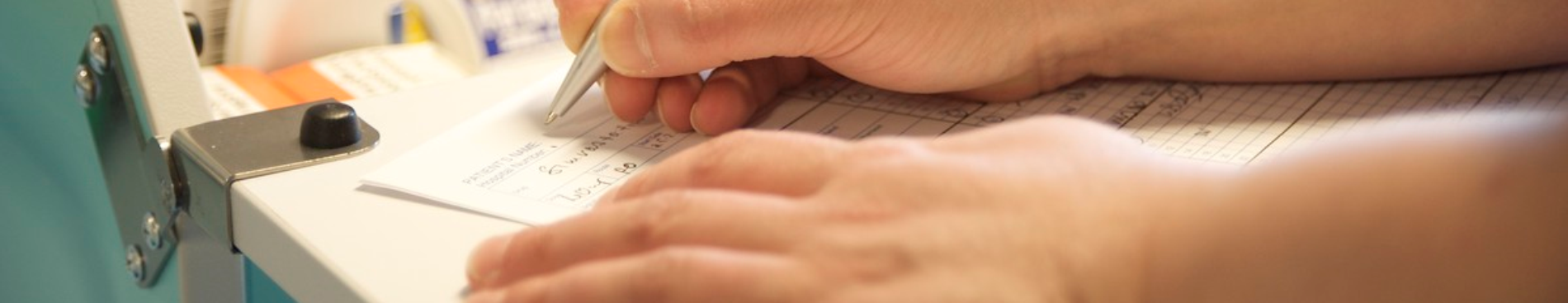 nurse filling in patient chart