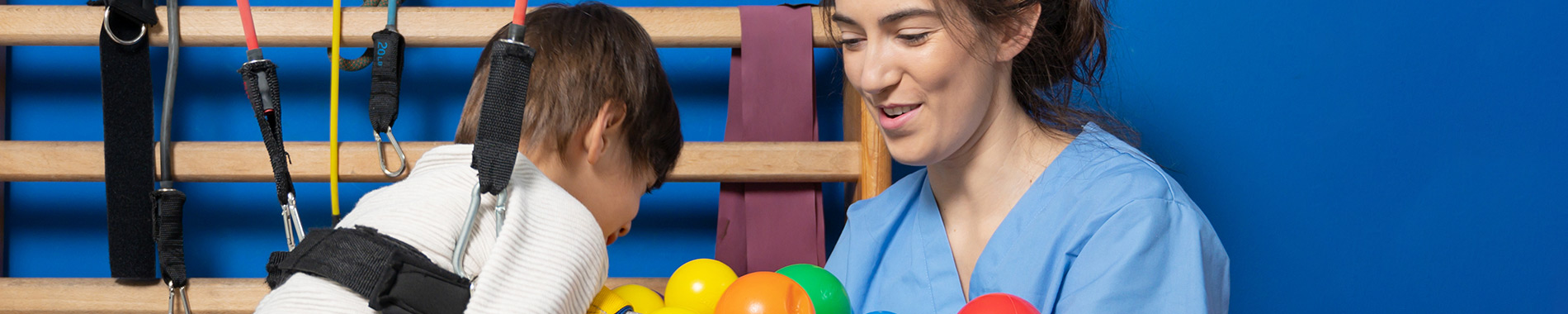 nurse and child playing with coloured balls