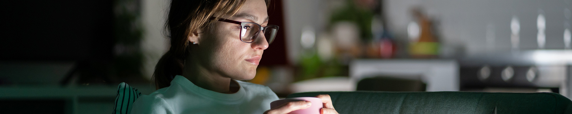 woman looking at her laptop in the dark