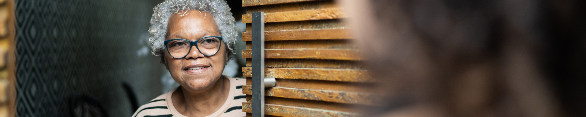 elderly woman opening door to nurse