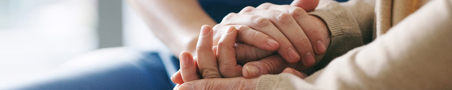 man holding hands with elderly woman