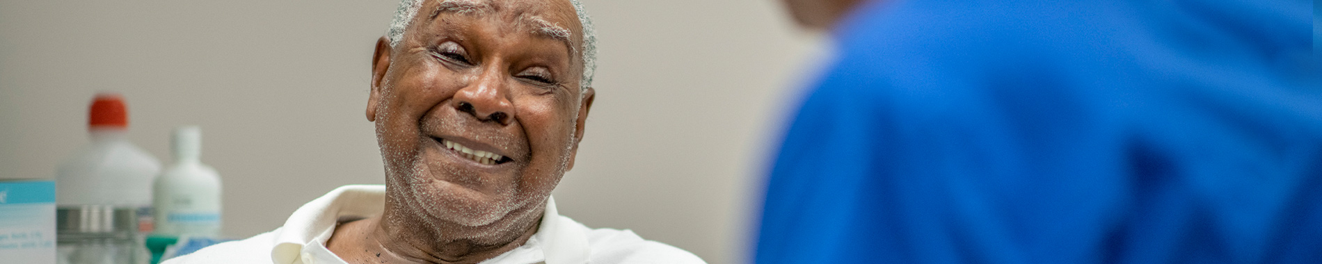 elderly man chatting to nurse