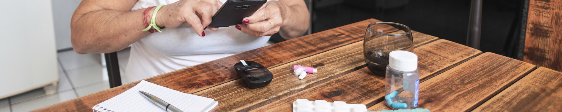 woman at table with medication