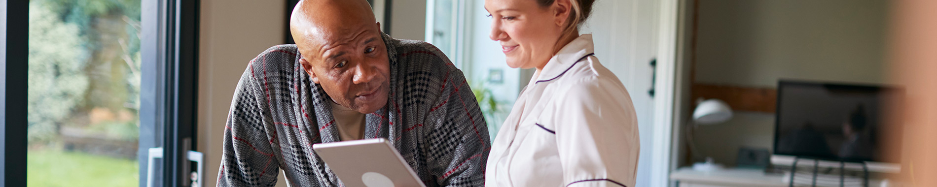 nurse using tablet with a patient