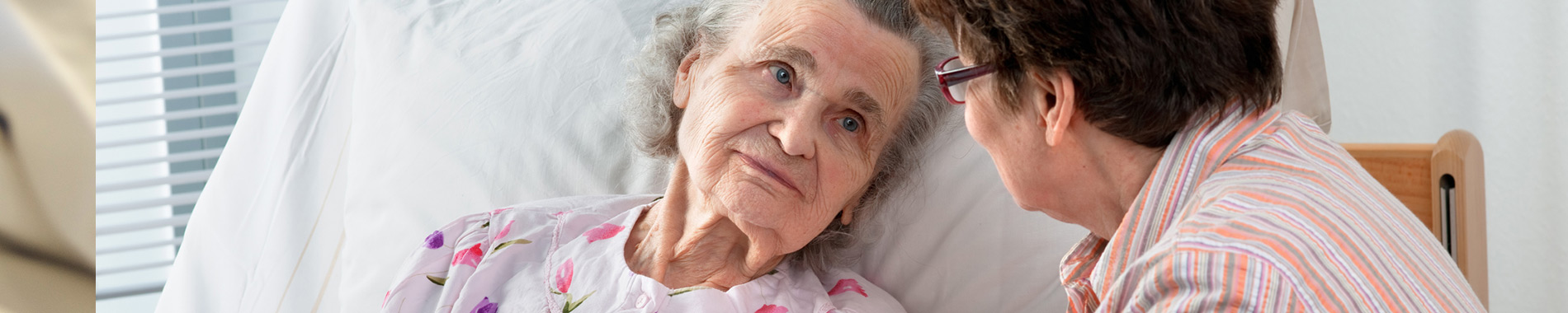 elderly woman in hospital bed