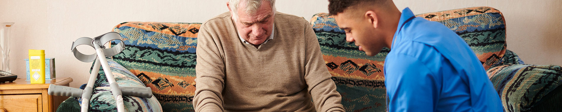 nurse assisting elderly man