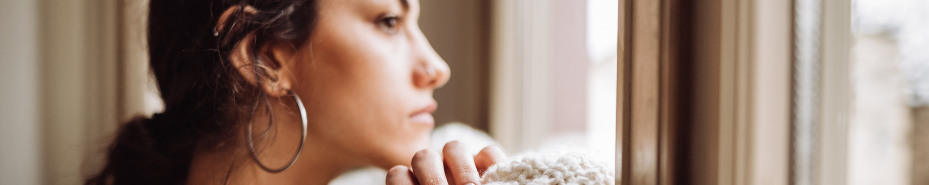 woman looking pensively out window