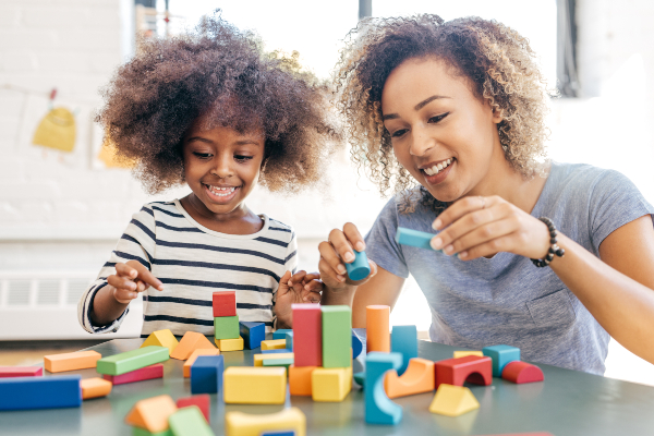 Woman and child playing with building blocks