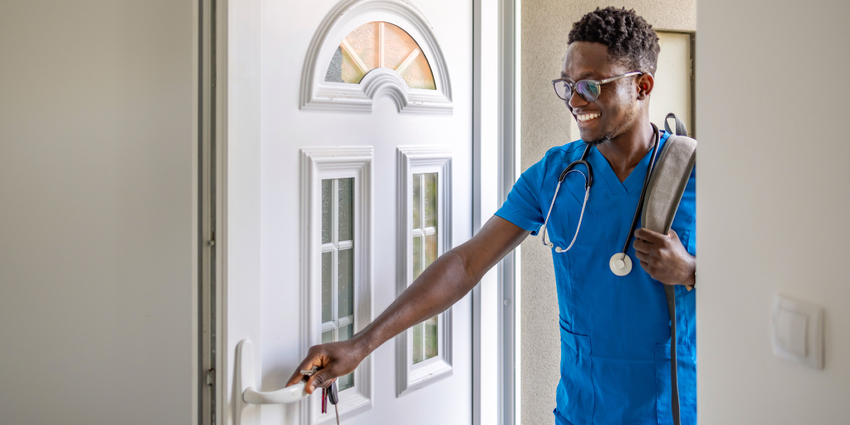 Black male nurse opening front door