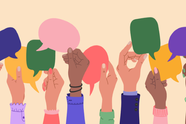 Several hands of diverse backgrounds holding talking bubbles in different colours