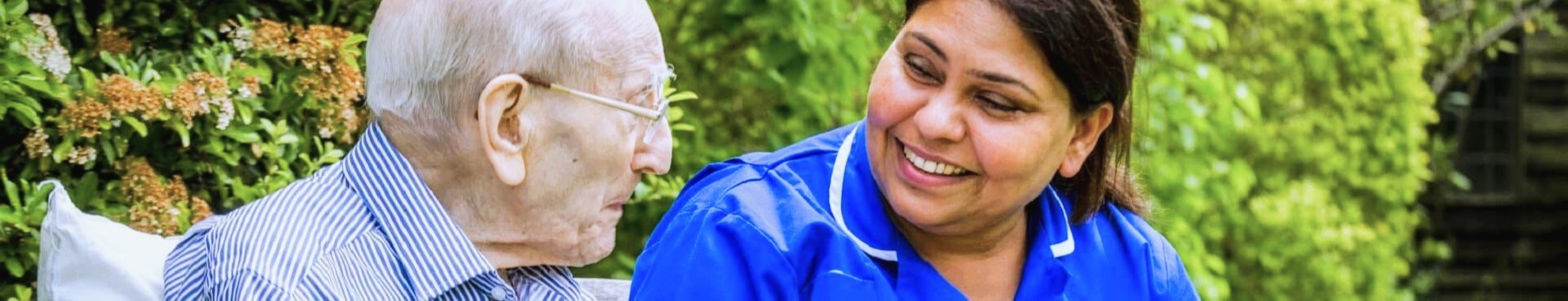 A Nurse smiling and talking with a patient