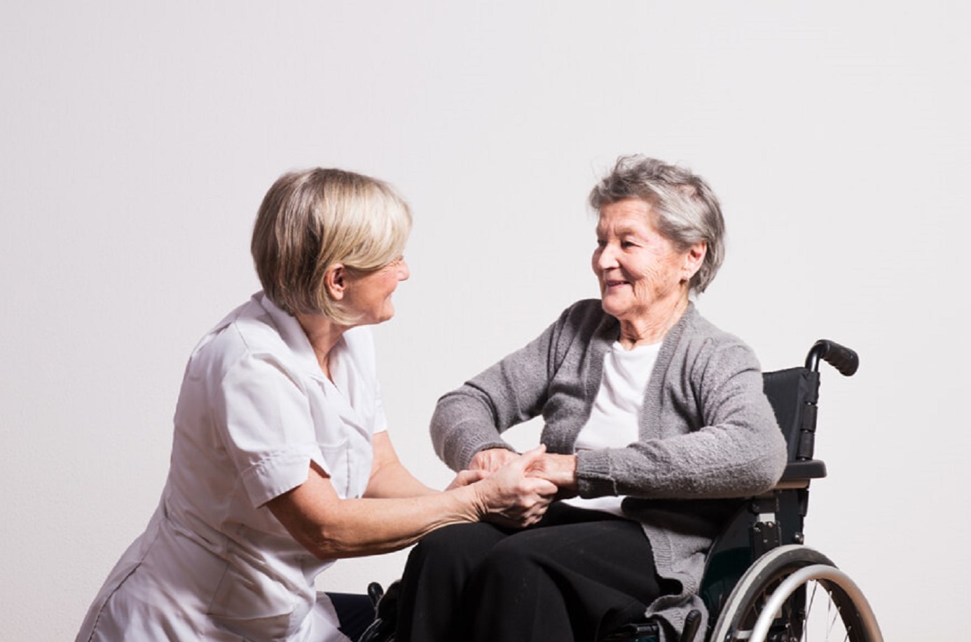 studio-portrait-of-a-senior-nurse-and-an-elderly-w