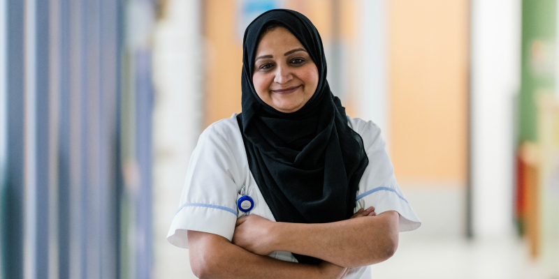 Image of smiling nurse with arms folded
