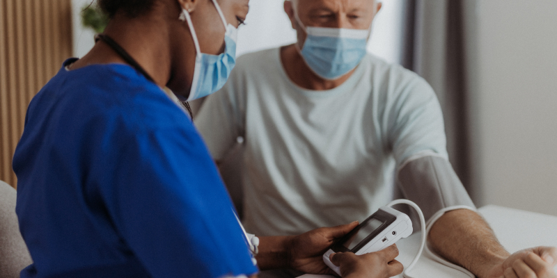Healthcare worker taking blood pressure