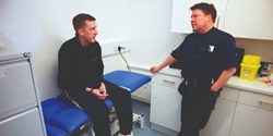 Prison officer talking to prisoner