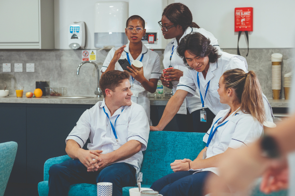 A group of nursing staff chatting in a break room