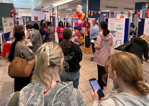 Conference attendees listening to a speaker