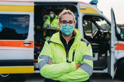 Image of healthcare worker in front on an amublance