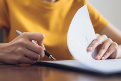 Image of person signing contract