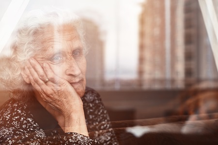 Old lady looking out of window