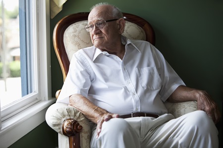 Old man looking out of window