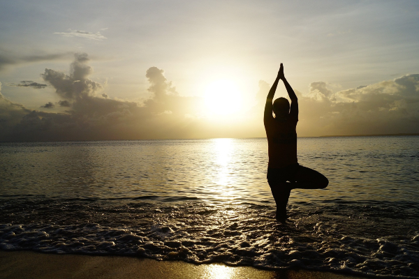 Image of person doing yoga on the beach