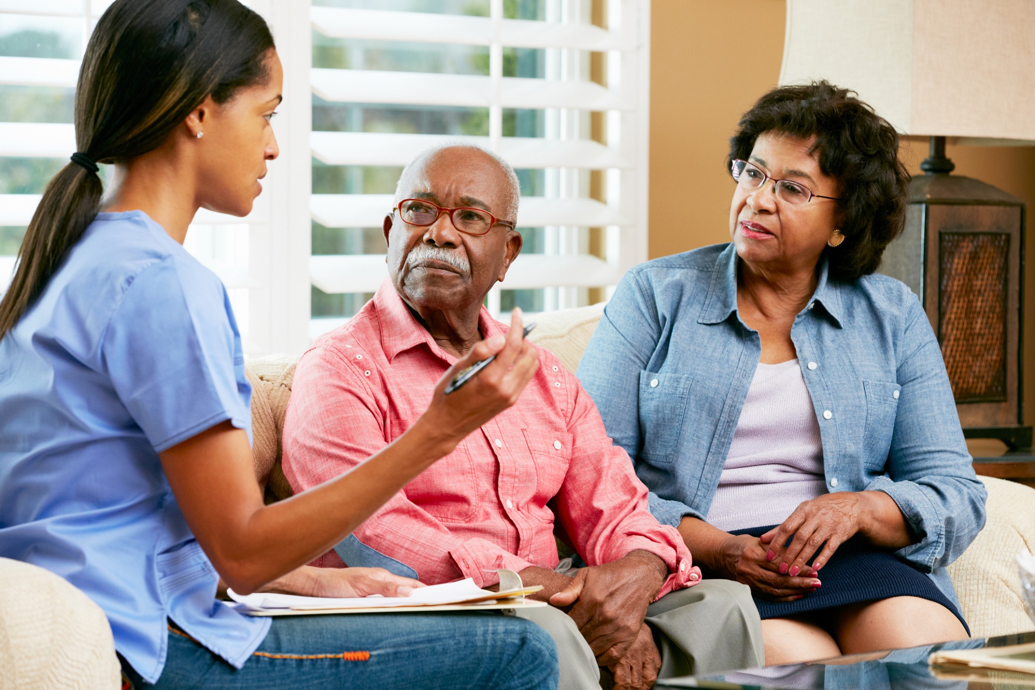 Nurse talking to two people