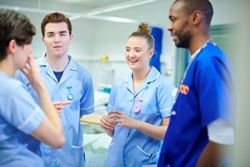 Four nurses chatting on ward