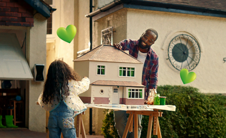 father and daughter playing with doll's house