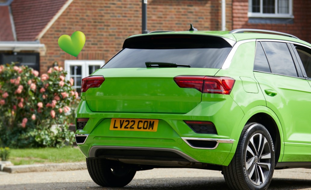 LV car insurance a bright green car outside a house